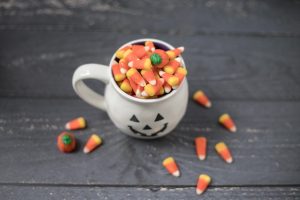 candies in mug and wooden surface