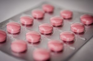 Pink round medication pill